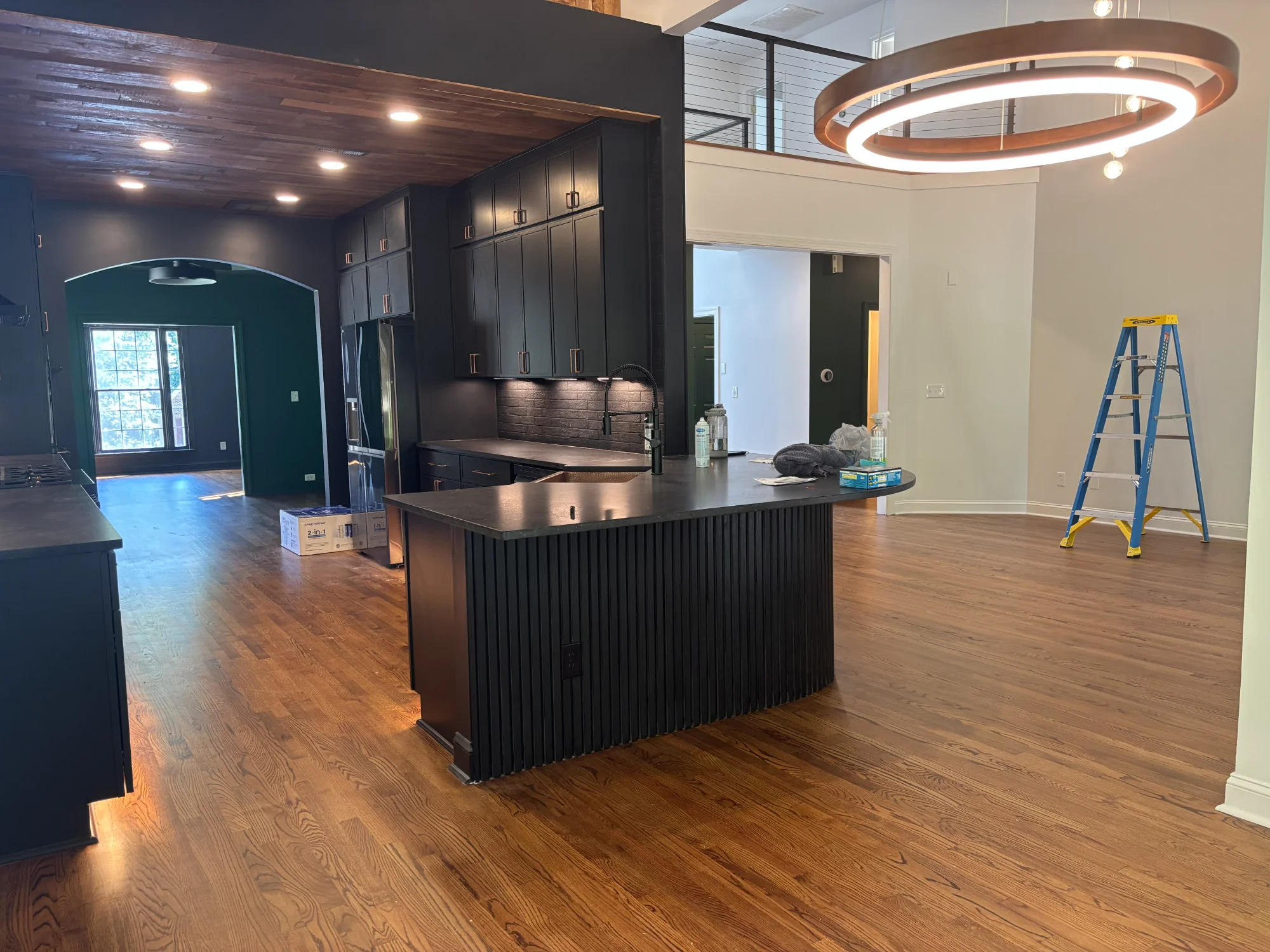 Modern kitchen with black cabinets and walnut accents